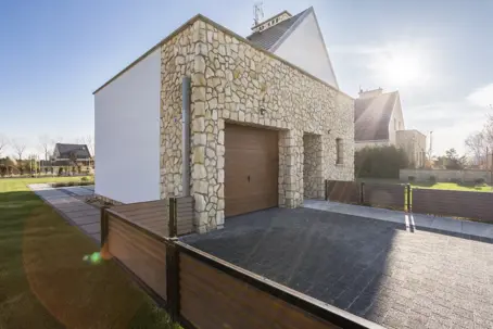 modern stone garage with a wood-style door
